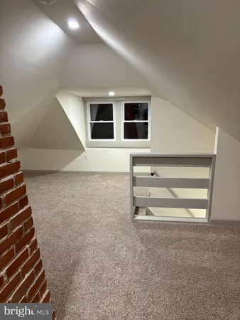 a view of empty room with a fireplace