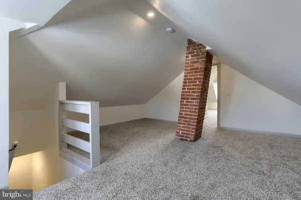 a view of hallway with windows and cabinet