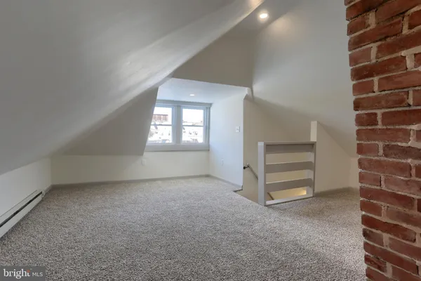 an empty room with a empty space and windows