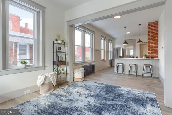 a kitchen with a sink a counter space appliances and cabinets