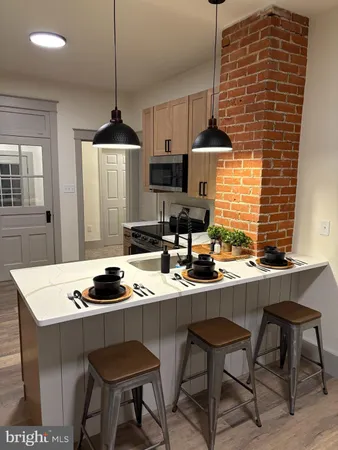 a kitchen with stainless steel appliances granite countertop a sink refrigerator and microwave