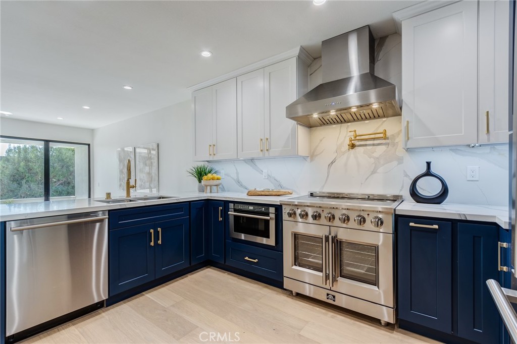 11919 Mayfield Avenue, Unit 2 Los Angeles, CA 90049 - Photo 2 of 75 a kitchen with a stove and cabinets