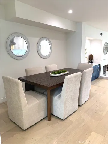 a backyard of a house with table and chairs and potted plants