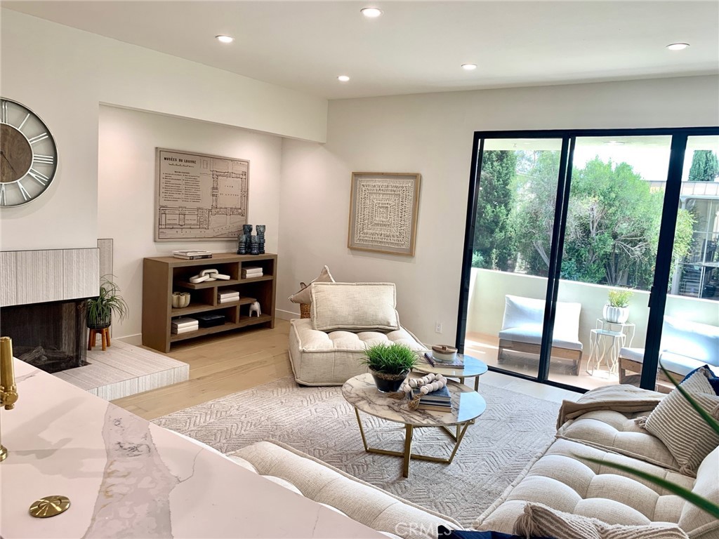 11919 Mayfield Avenue, Unit 2 Los Angeles, CA 90049 - Photo 26 of 75 a living room with furniture and a floor to ceiling window