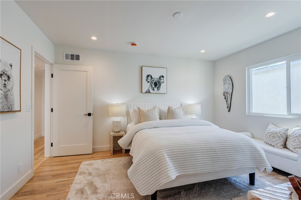 11919 Mayfield Avenue, Unit 2 Los Angeles, CA 90049 - Photo 35 of 75 a bedroom with a bed and a window