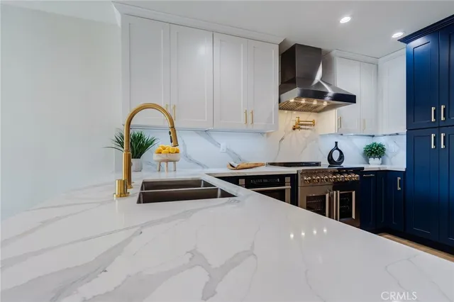 a kitchen with stainless steel appliances a stove and a refrigerator