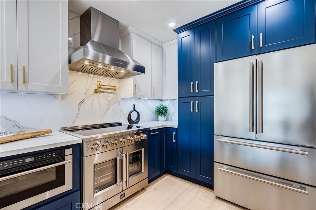 11919 Mayfield Avenue, Unit 2 Los Angeles, CA 90049 - Photo 6 of 75 a kitchen with stainless steel appliances a stove and a refrigerator