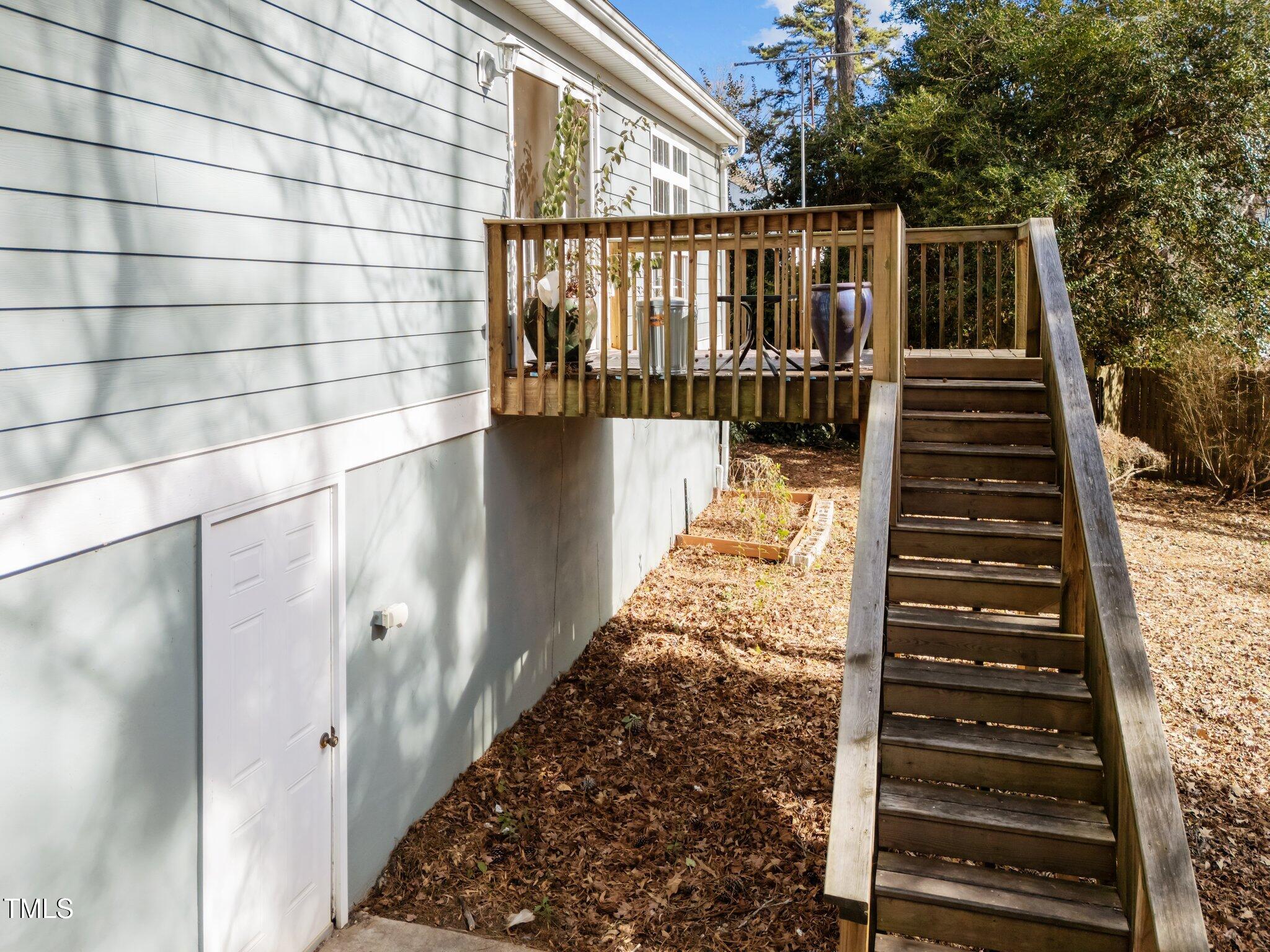 2719 Gordon Street Raleigh, NC 27608 - Photo 30 of 38 Easy access to the fully fenced backyard and walk-in crawlspace and storage area.