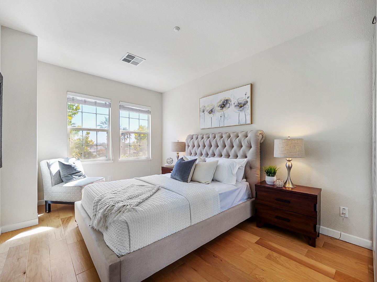 1144 Le Mans Terrace Sunnyvale, CA 94089 - Photo 16 of 29 a bedroom with a bed and wooden floor