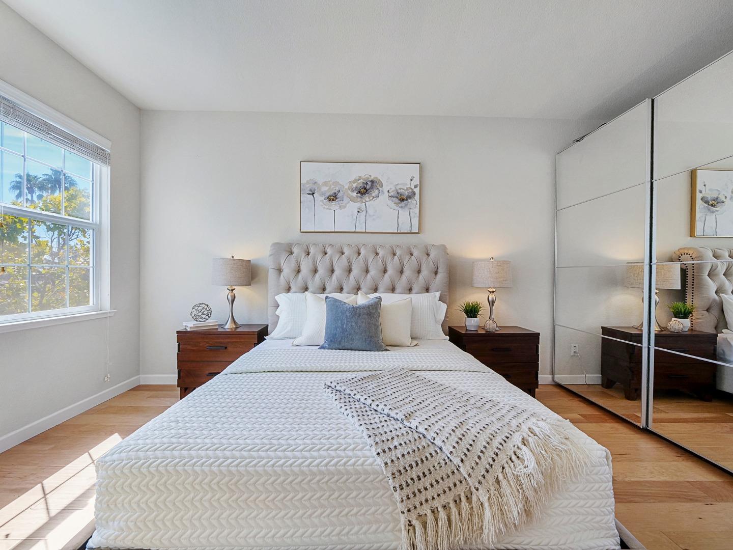 1144 Le Mans Terrace Sunnyvale, CA 94089 - Photo 17 of 29 a bedroom with a large bed and a chandelier