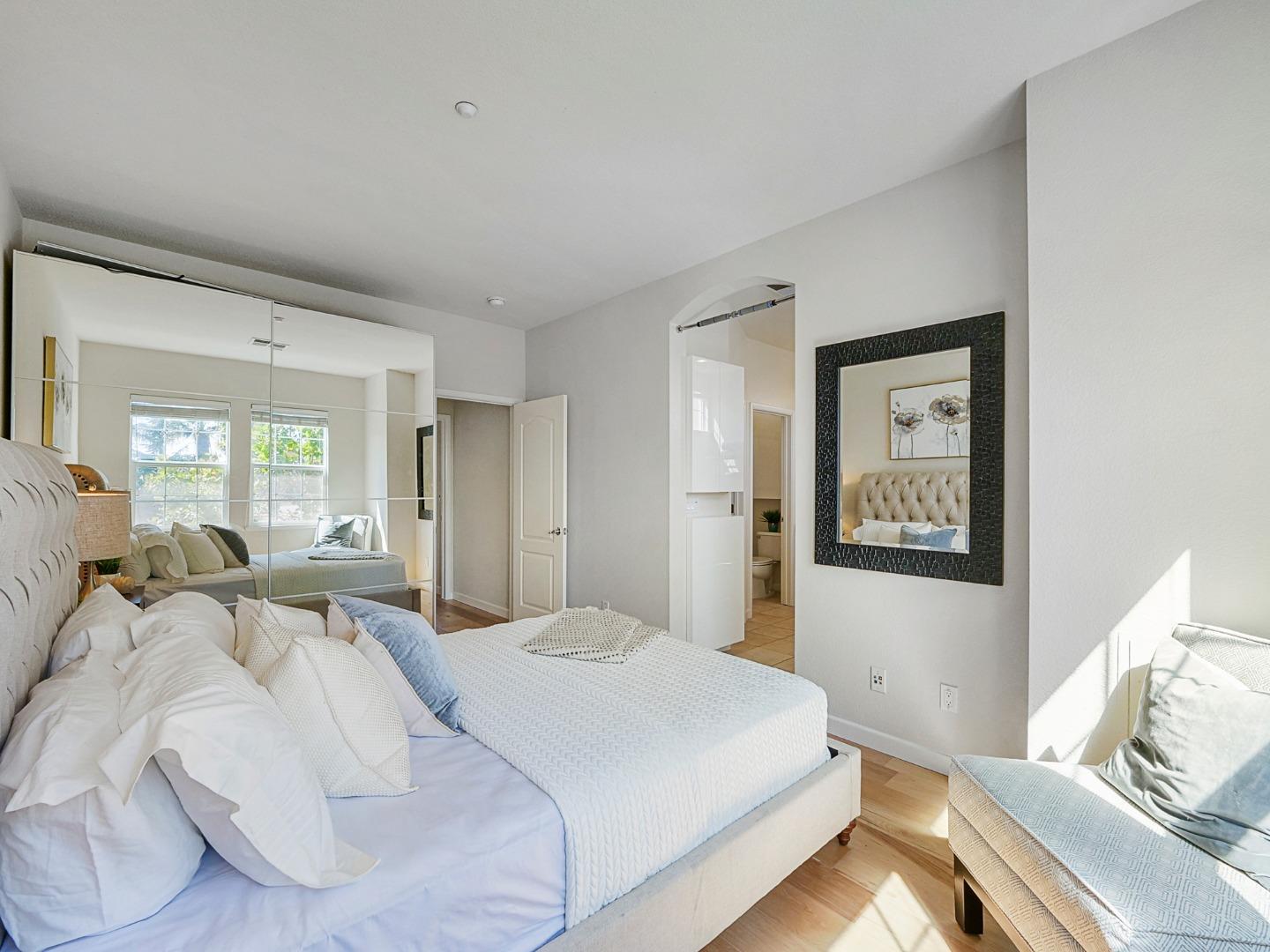 1144 Le Mans Terrace Sunnyvale, CA 94089 - Photo 18 of 29 a bedroom with a bed and wooden floor