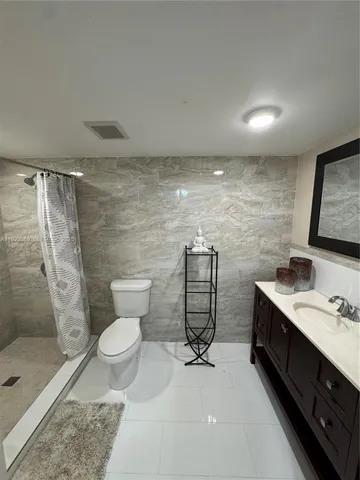 a bathroom with a toilet sink and shower