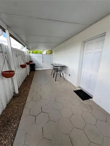 a hallway with a large mirror and a shower