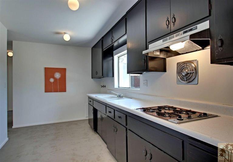 70080 Chappel Road Rancho Mirage, CA 92270 - Photo 13 of 24 a kitchen with stainless steel appliances granite countertop a stove and a sink