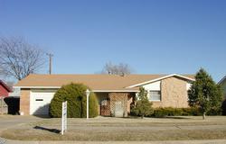 5213 South Travis Street Amarillo, TX 79110 - Photo 1 of 1 a front view of a house with a yard