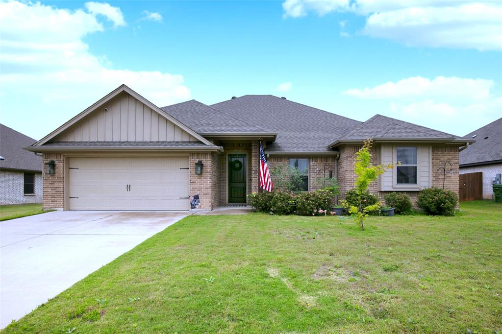 211 Rees Avenue Godley, TX 76044 - Photo 2 of 18 a front view of a house with garden