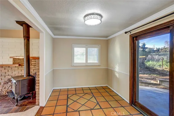 a view of a livingroom with a window and wooden floor