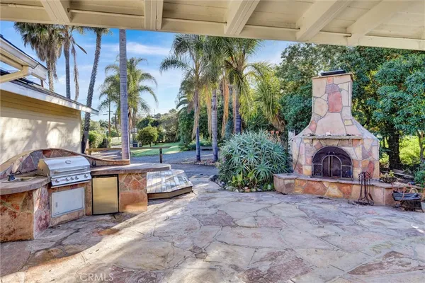 a view of a patio with couches and potted plants