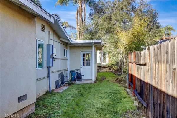 a view of house with backyard