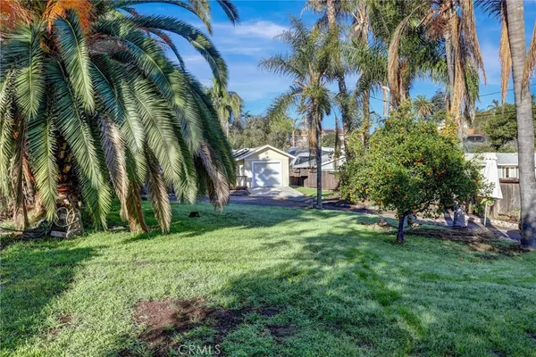 a view of yard with swimming pool and green space