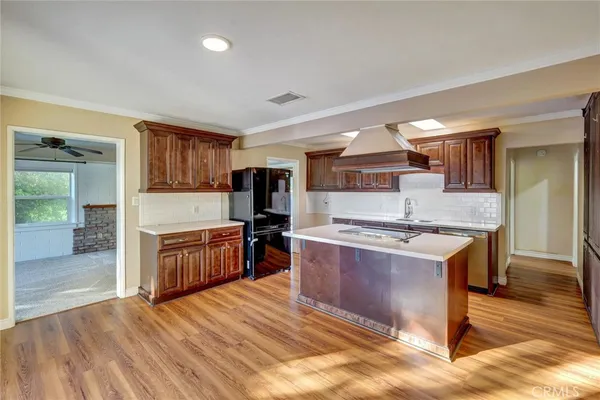 a large kitchen with stainless steel appliances granite countertop a stove and a sink