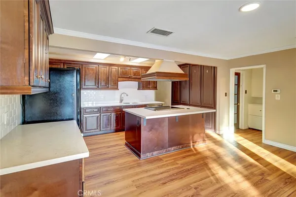 a large kitchen with stainless steel appliances granite countertop a stove and a sink
