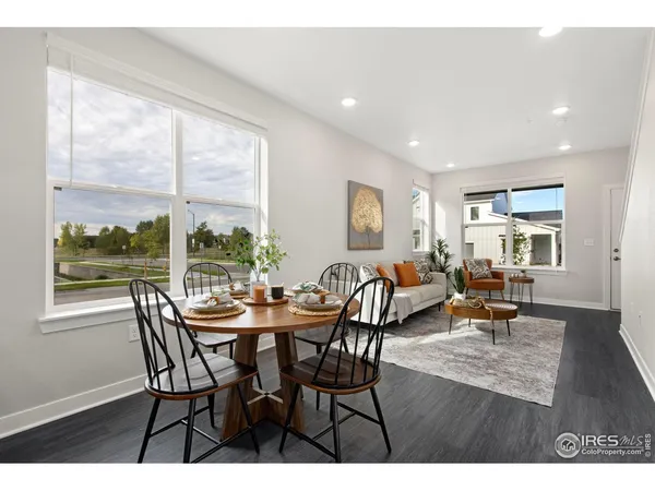 a view of a dining room with furniture and a window