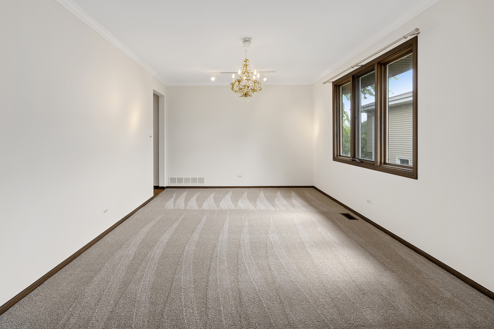 7019 Camden Road Downers Grove, IL 60516 - Photo 14 of 25 an empty room with wooden floor chandelier and windows