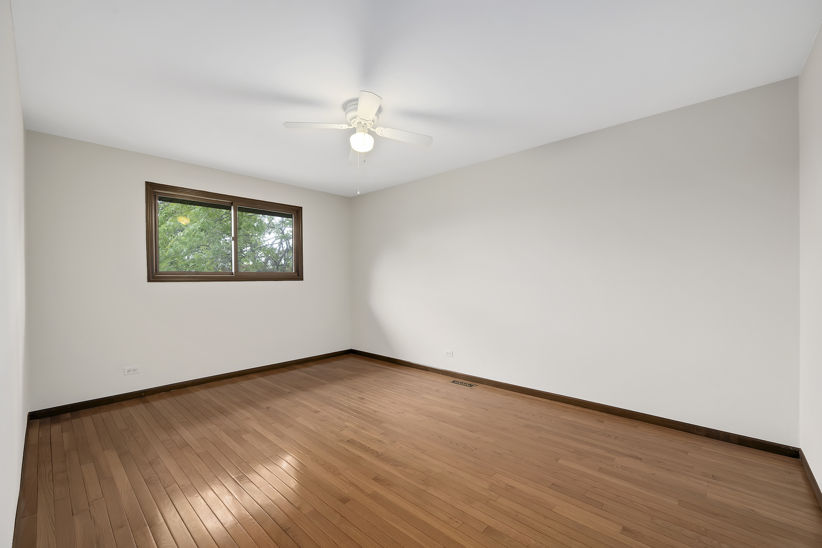 7019 Camden Road Downers Grove, IL 60516 - Photo 16 of 25 a view of an empty room with wooden floor and a window