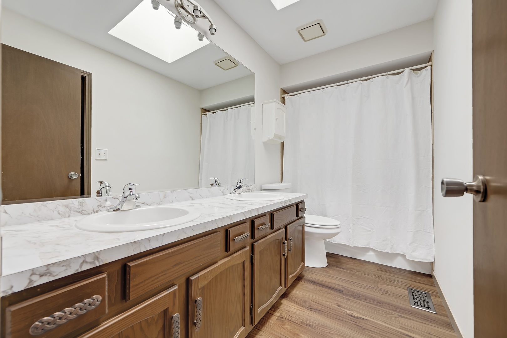 7019 Camden Road Downers Grove, IL 60516 - Photo 17 of 25 a bathroom with a double vanity sink and mirror