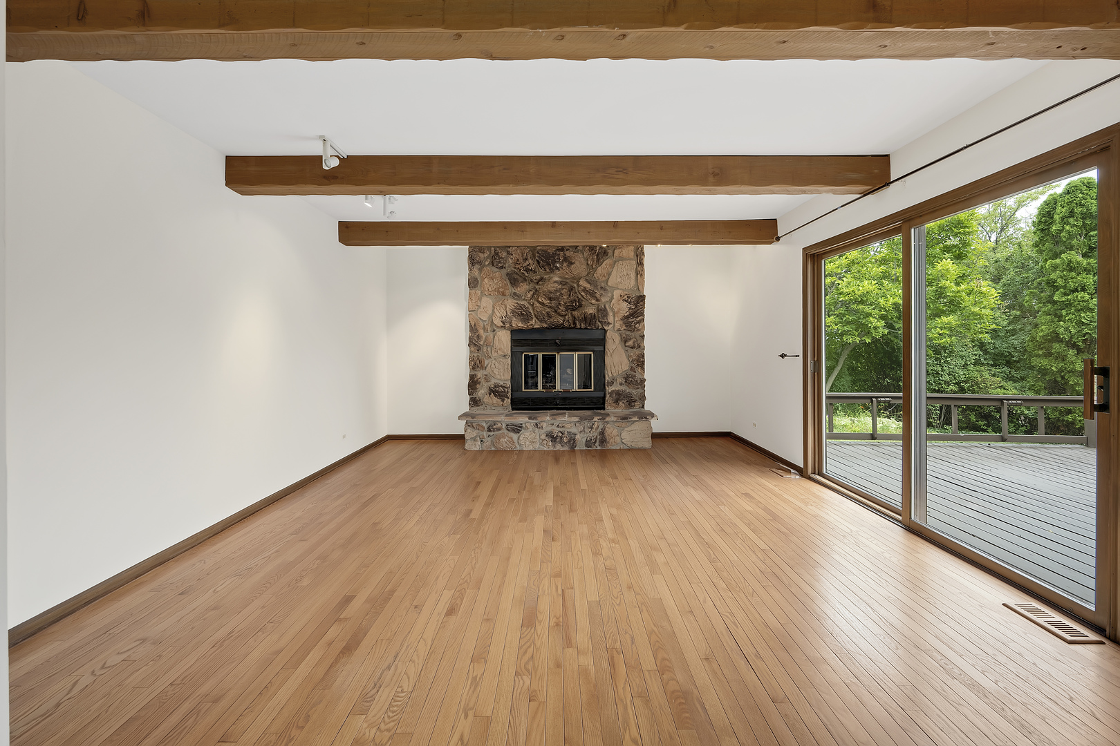 7019 Camden Road Downers Grove, IL 60516 - Photo 4 of 25 a view of empty room with wooden floor and fireplace