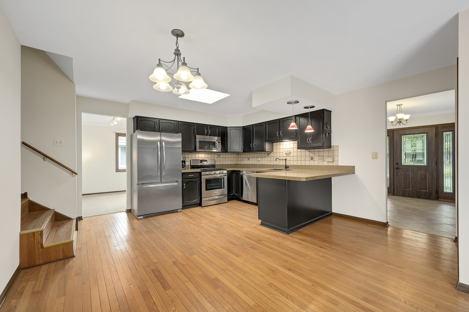 7019 Camden Road Downers Grove, IL 60516 - Photo 5 of 25 a kitchen with stainless steel appliances kitchen island granite countertop a stove top oven and sink