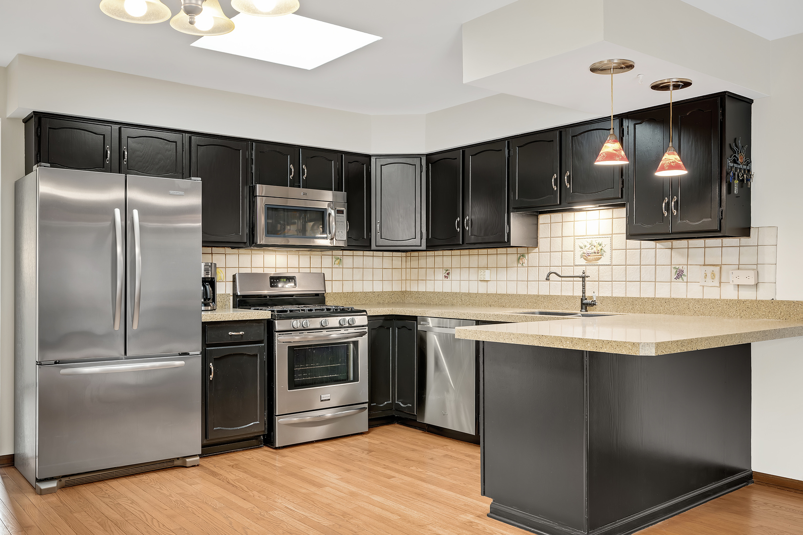 7019 Camden Road Downers Grove, IL 60516 - Photo 7 of 25 a kitchen with a sink stainless steel appliances and cabinets