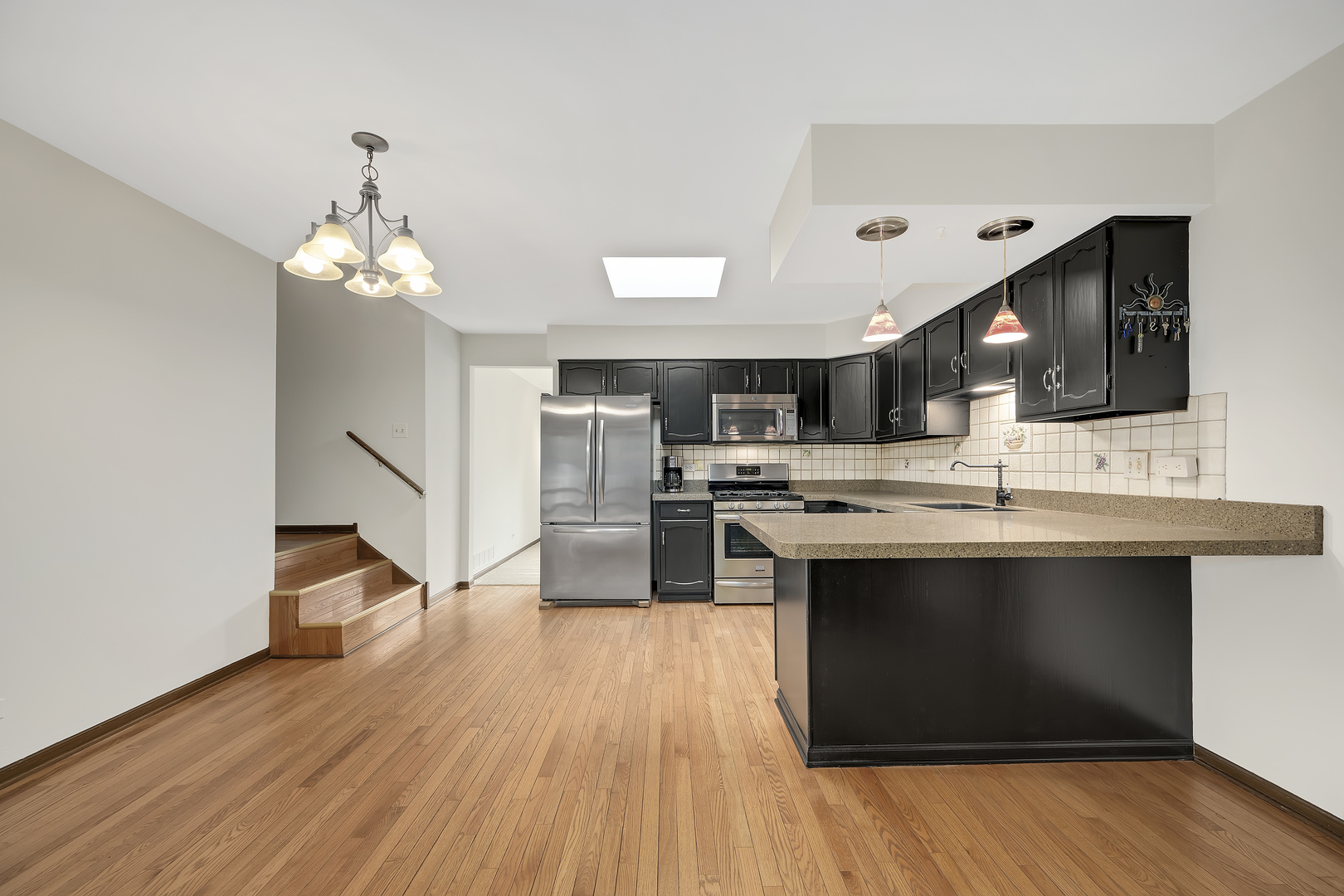 7019 Camden Road Downers Grove, IL 60516 - Photo 8 of 25 a kitchen with stainless steel appliances a stove top oven and cabinets