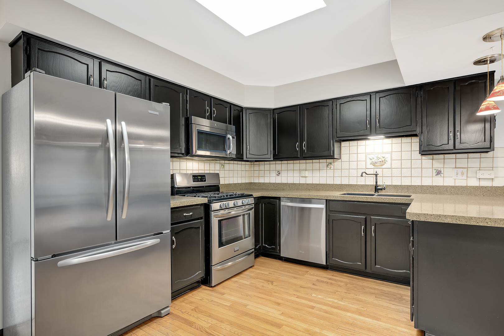 7019 Camden Road Downers Grove, IL 60516 - Photo 9 of 25 a kitchen with granite countertop stainless steel appliances and wooden cabinets