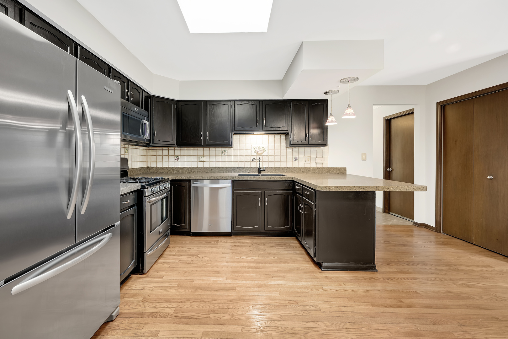 7019 Camden Road Downers Grove, IL 60516 - Photo 10 of 25 a kitchen with stainless steel appliances granite countertop a stove a sink dishwasher and a refrigerator