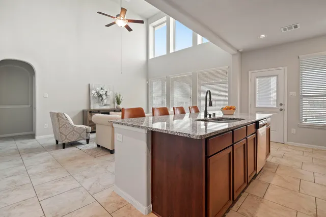 a kitchen with granite countertop a sink and cabinets