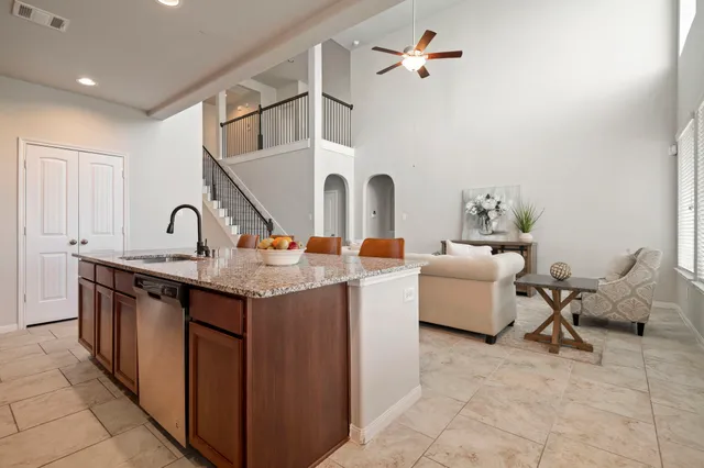 a living room with furniture a rug and white walls