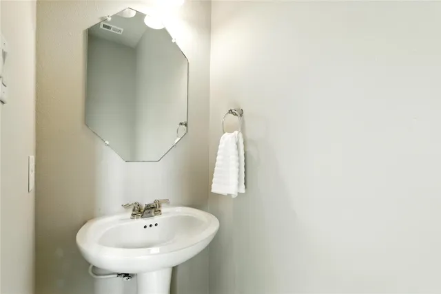 a bathroom with a sink and mirror