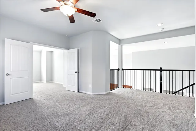 a view of a room with a ceiling fan