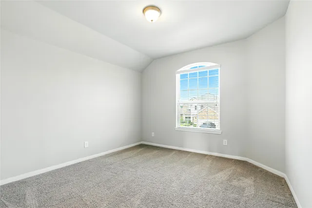 a bathroom with a bathtub shower sink vanity mirror and toilet