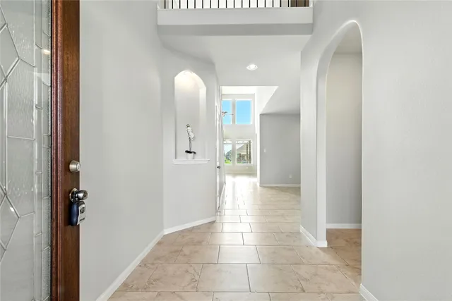 a view of a hallway with wooden cabinets