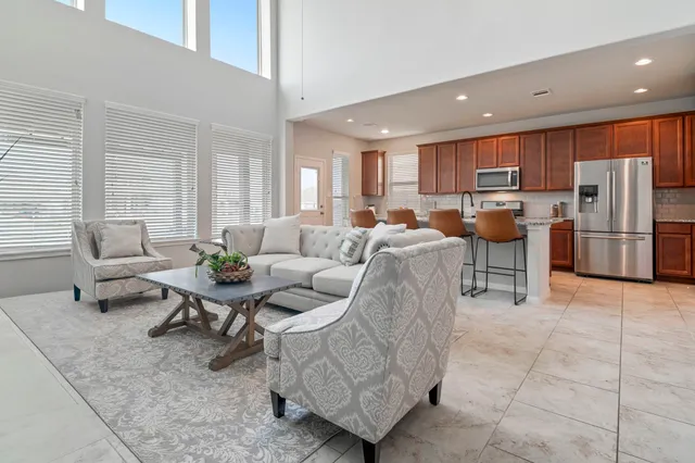 a living room with furniture and a open kitchen view