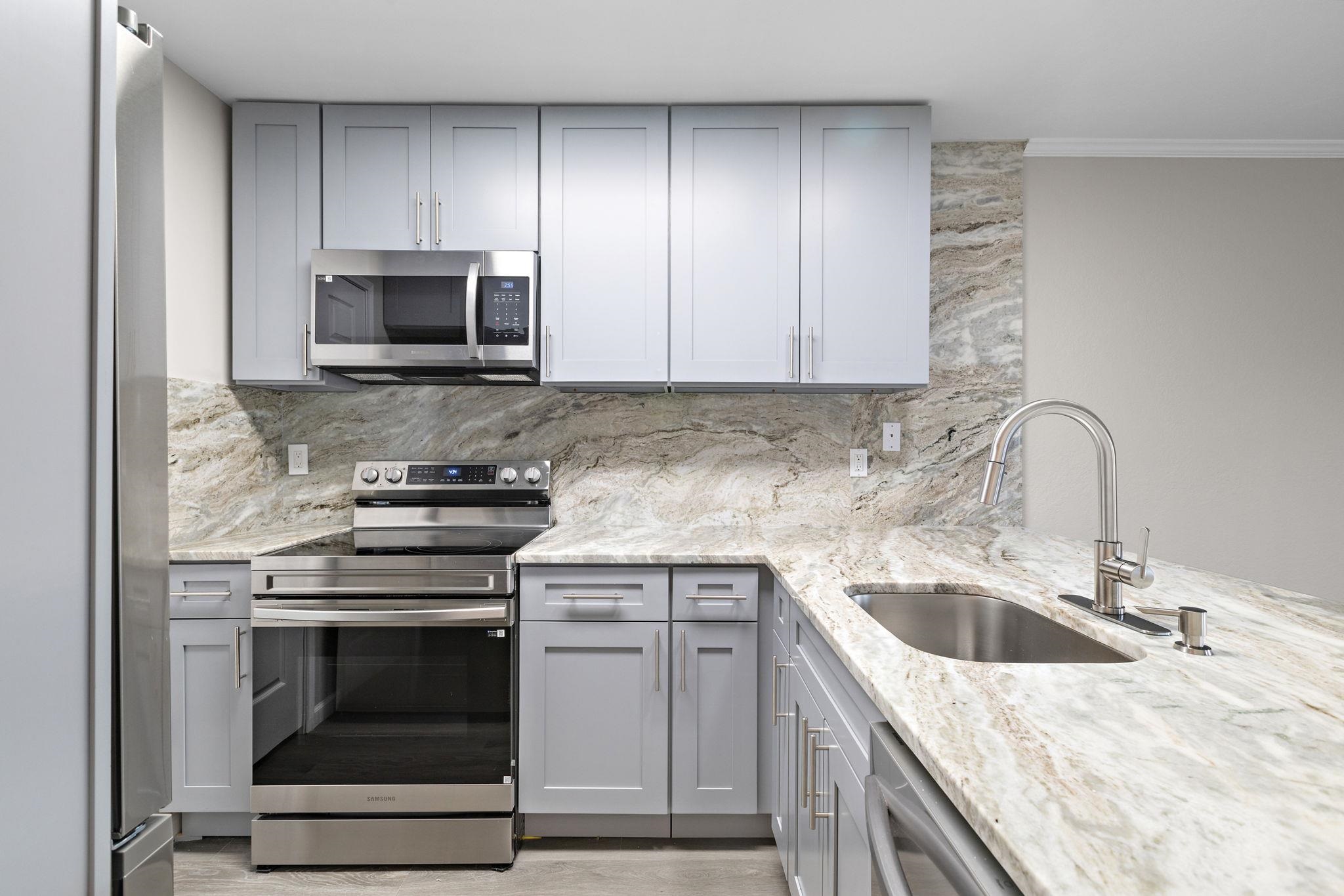 690 Route 23 Wayne Nj 07470, Unit R3 Wayne, NJ 07470 - Photo 4 of 13 a kitchen with white cabinets appliances and sink