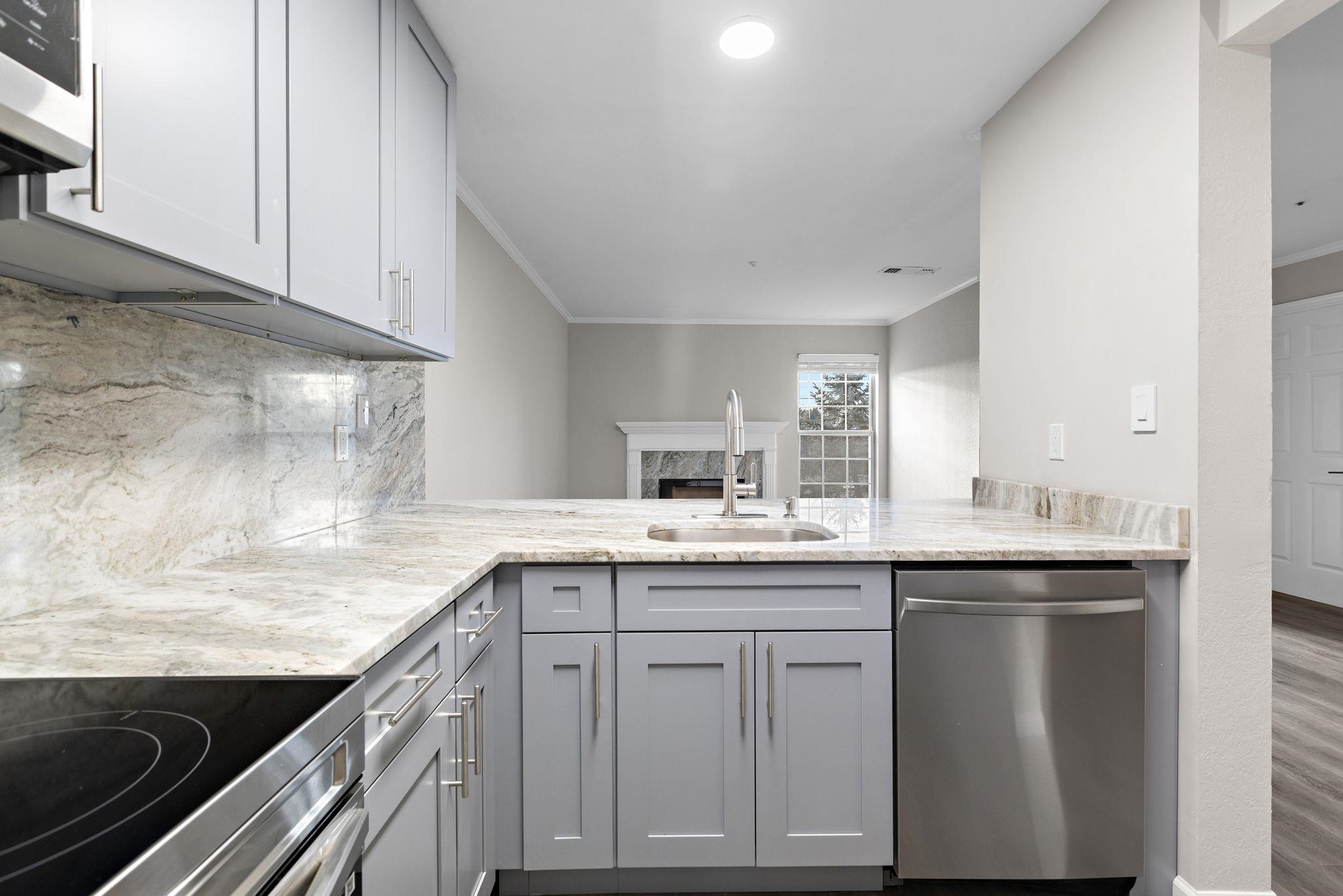 690 Route 23 Wayne Nj 07470, Unit R3 Wayne, NJ 07470 - Photo 5 of 13 a kitchen with granite countertop a sink and cabinets