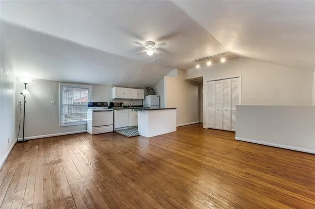 a view of a kitchen with a sink and a stove top oven