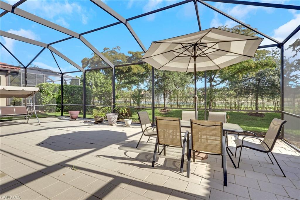 16309 Aberdeen Way Naples, FL 34110 - Photo 30 of 34 a patio with a patio table and chairs