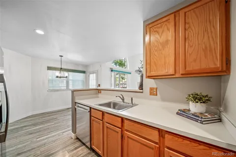 a kitchen with stainless steel appliances granite countertop wooden cabinets a sink and dishwasher
