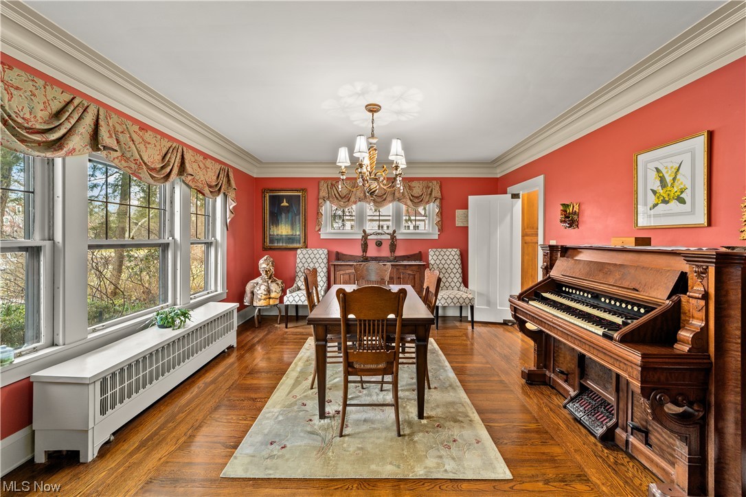 2745 Leighton Road Cleveland, OH 44120 - Photo 4 of 46 Dining space with an inviting chandelier, dark hardwood / wood-style flooring, ornamental molding, and radiator