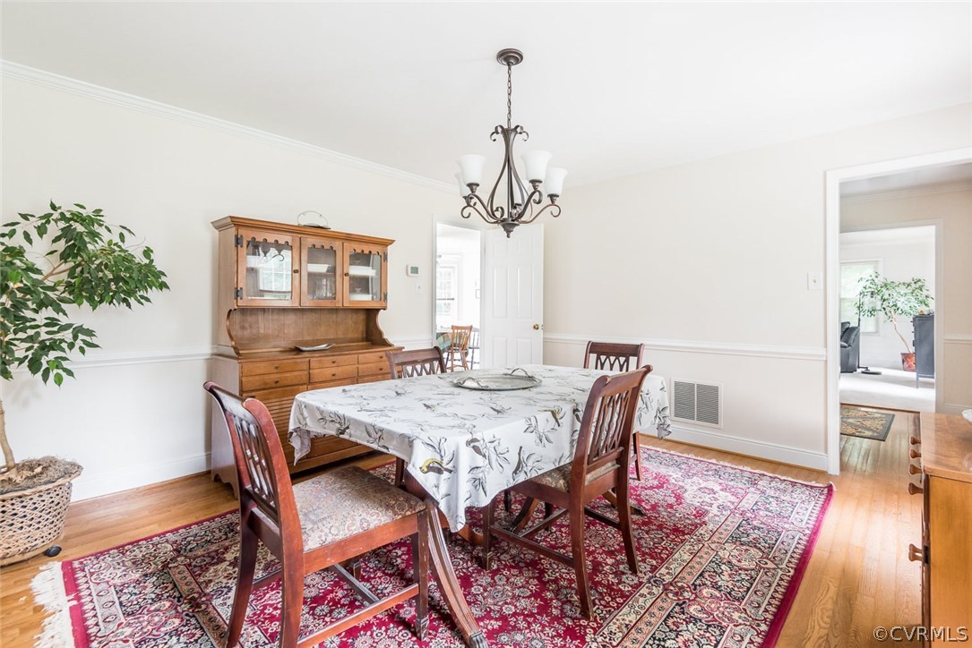 13224 Queensgate Road Midlothian, VA 23114 - Photo 17 of 32 a view of a dining room with furniture wooden floor and chandelier